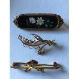 Three brooches in 9, 14 and 15 carat gold.