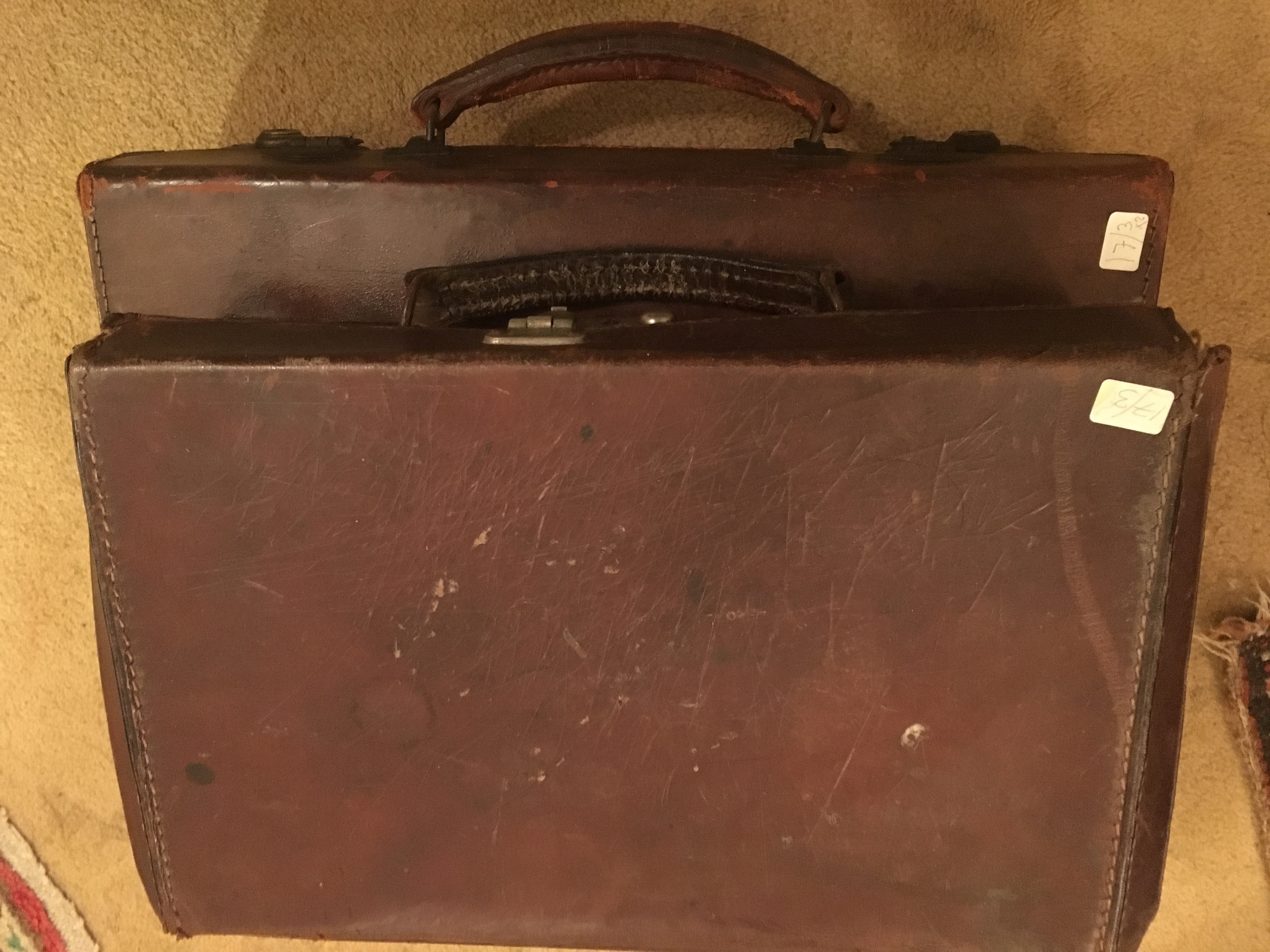 Two small leather suitcases and a gentlemans briefcase with brass fittings