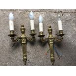 Two brass two light wall sconces.