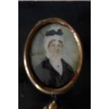 Oval P M on ivory a lady with black dress, black bow and white headdress 7.5cm