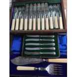 Boxed fish servers, fish knives and forks and silver handled cake knives.