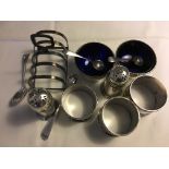 Silver condiment set, toast rack, napkin rings and spoons.