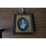 Oval portrait miniature 19thc young lady in blue dress in gilt metal frame on ivory. 6.3cms.