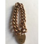 Nine carat gold chain link bracelet with padlock fastening. 27.9gms approximately.