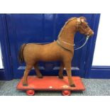 Vintage pull along horse on wheels. 63cms long.