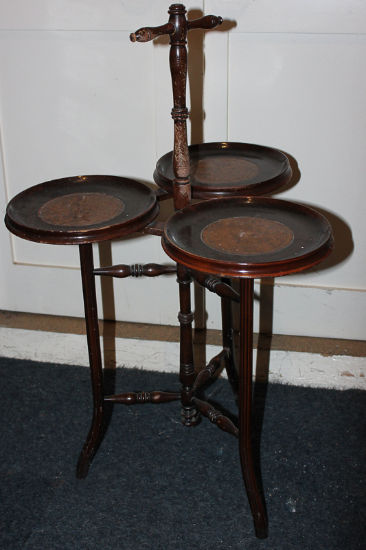 A turned mahogany three dish side table on tripod legs