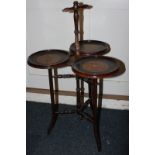 A turned mahogany three dish side table on tripod legs