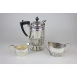 A Victorian matched silver three piece set of hot coffee pot, sugar bowl and milk jug, with half