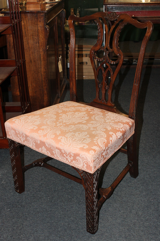 A Chippendale style mahogany dining chair with pierced ribbon splat, pink damask upholstered seat on