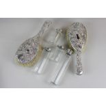 A pair of silver backed hair brushes,  leaf and scroll design, Birmingham 1890; and four silver