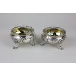 A pair of Victorian silver salts with embossed bodies on pad feet with gilded interior, maker Joseph