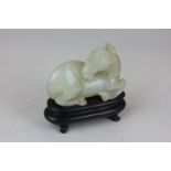 A Chinese mutton fat jade horse on hardwood stand, 6cm wide