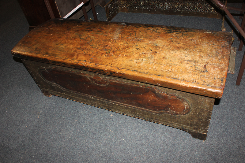 An 18th century continental fruitwood coffer, the domed top with central carved star motif,