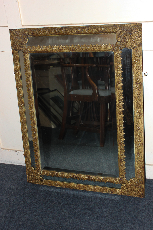 A Venetian style rectangular gilt wall mirror with mirror panelled border and foliate decoration,