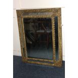 A Venetian style rectangular gilt wall mirror with mirror panelled border and foliate decoration,