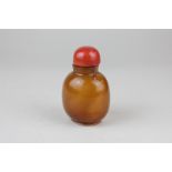 A Chinese amber glass snuff bottle, 9cm high
