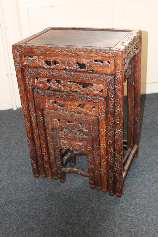 A nest of five Chinese hardwood tables, the sides and legs carved with grapevines, 46cm wide, (NC) - Image 2 of 2