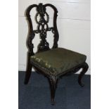 A mahogany dining chair, with elaborately carved ribbon back, green damask upholstered seat, on