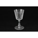 An early 20th century etched wine glass in presentation box with a heart shaped cartouche