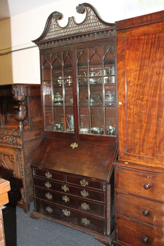 A George III mahogany bureau bookcase, with pierced swan neck surmount (a/f), above glazed panel
