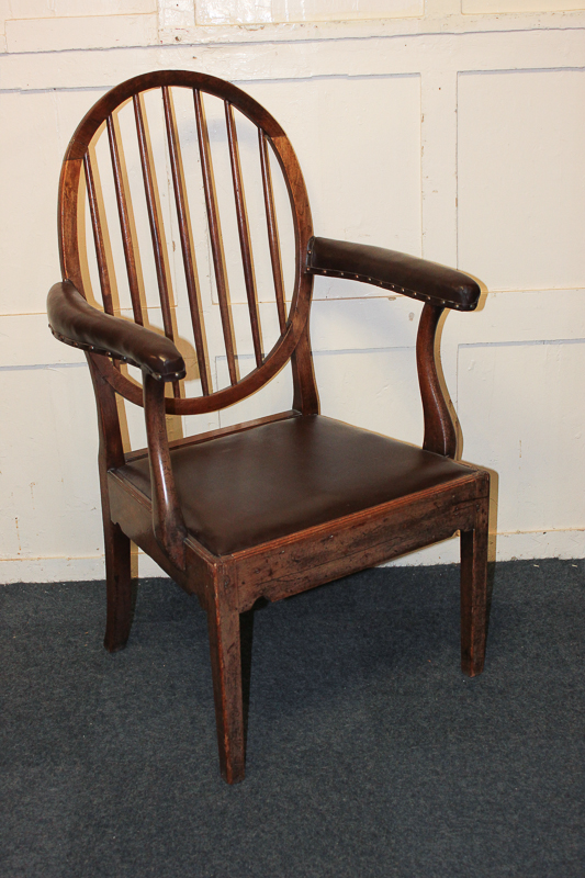 A 19th century slat back carver dining chair with padded arms, on square tapered legs