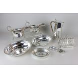 A pair of silver plated sauce boats, a toast rack, a coffee pot, a pair of nut crackers, two
