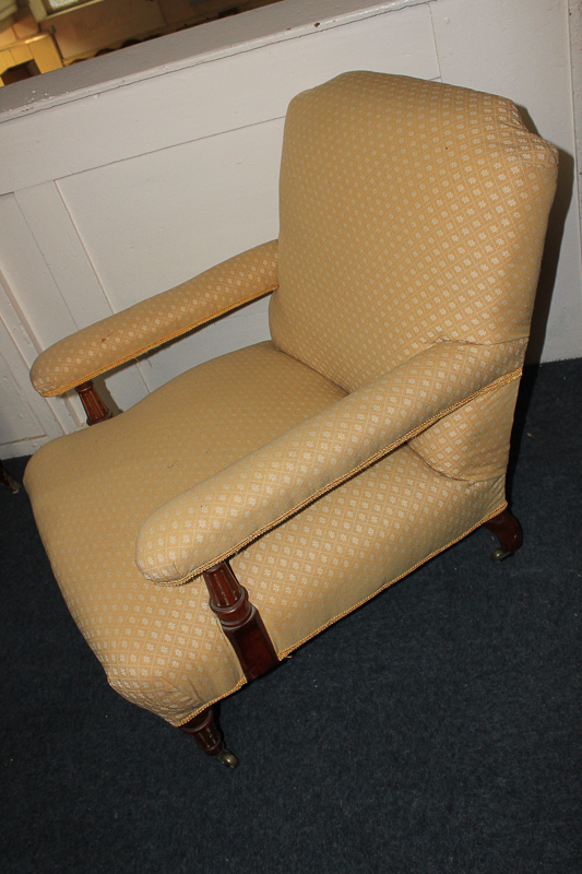 A Victorian upholstered armchair, with padded arms, on tapered supports and legs, in gold floral