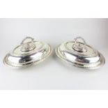 Two silver plated oval entree dishes with covers and gadroon borders