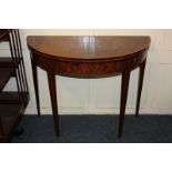 A cross banded and inlaid mahogany demi-lune card table with fold-over top and green baize lining,