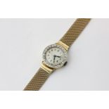 A lady's 18ct gold and diamond set watch on a 9ct gold mesh bracelet