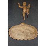 A carved gilt wood and gesso figure of a putti, holding aloft a shell shaped dish (now detached)