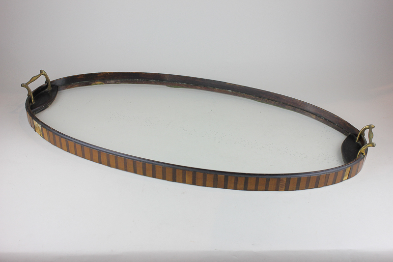 An Edwardian oval tea tray with inlaid banded edging around clear glass base, 69cm