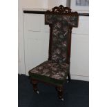 A Victorian prie dieu chair with pierced scroll surmount, tapestry upholstered back and seat
