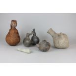 Five various African and South American pottery vessels including a belly figured jug