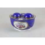 A 19th century Dresden porcelain inkwell, with hand painted floral central motif and blue and gilt
