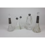Four Victorian and Edwardian silver topped cut glass bottles including an oil and vinegar curved