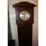 A 20th century oak longcase clock with silverised dial and Arabic numerals with Westminster