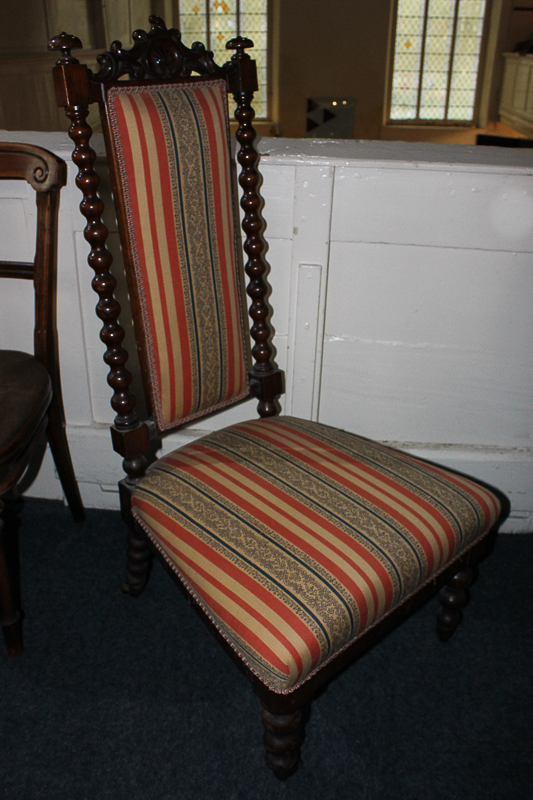 A Victorian nursing chair, with red striped upholstered back, and bobbin turned supports