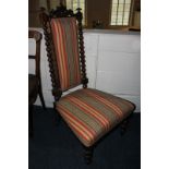 A Victorian nursing chair, with red striped upholstered back, and bobbin turned supports
