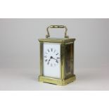 A brass and bevelled glass cased carriage clock the white enamelled face with Roman numerals 14cm