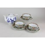 A set of three Chinese Cantonese famille rose scalloped tea cups and saucers, depicting figures in
