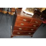 A 19th century oak chest, of two short over three long drawers, with oval brass handles, on