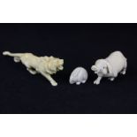 Three resin figures of animals modelled as a rabbit netsuke a lion and a pig (a/f)