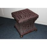 A Victorian work box stool, with square upholstered top, curved sides, on bun feet, 47cm