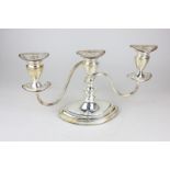 A silver plated candelabra with three sconces and ovoid form