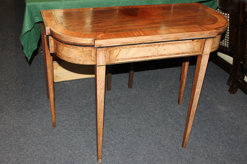 A Sheraton style inlaid mahogany card table, with crossbanded breakfront top, opening to reveal