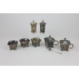 A George V silver matched part cruet set in quatrefoil form, including three salts, two peppers, two