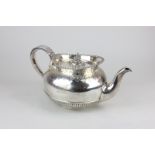 A George V silver teapot with beaded edge, banded handle and chased decoration, maker Hunt & Roskell