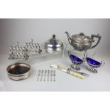 A silver plated muffin dish, two silver plated boat shaped salts with blue glass liners, a wine