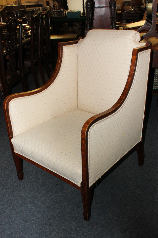 An Edwardian armchair, in cream lattice design upholstery, with crossbanded surround, on square